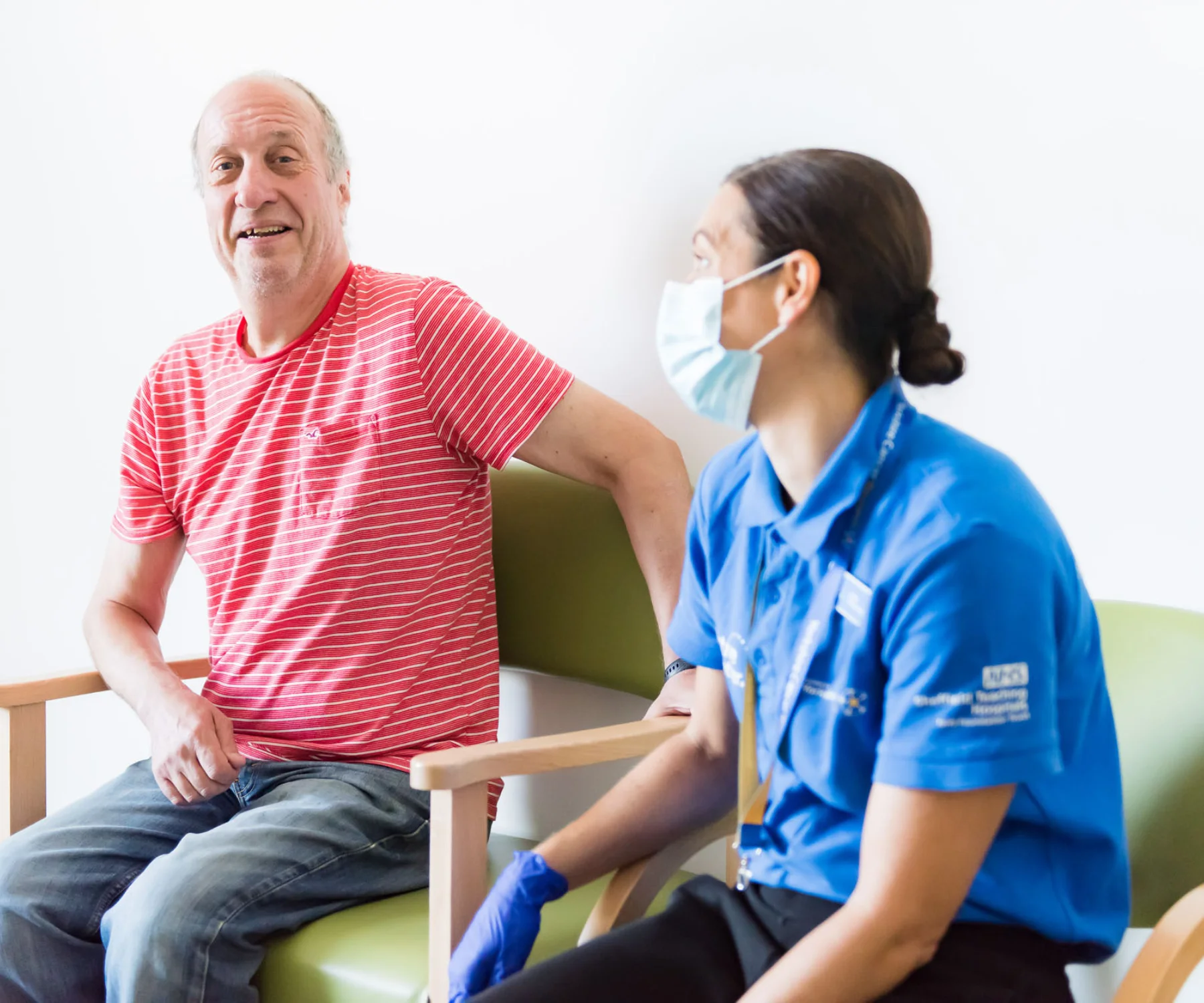 Patient looking happy in a consultation room with a clinician