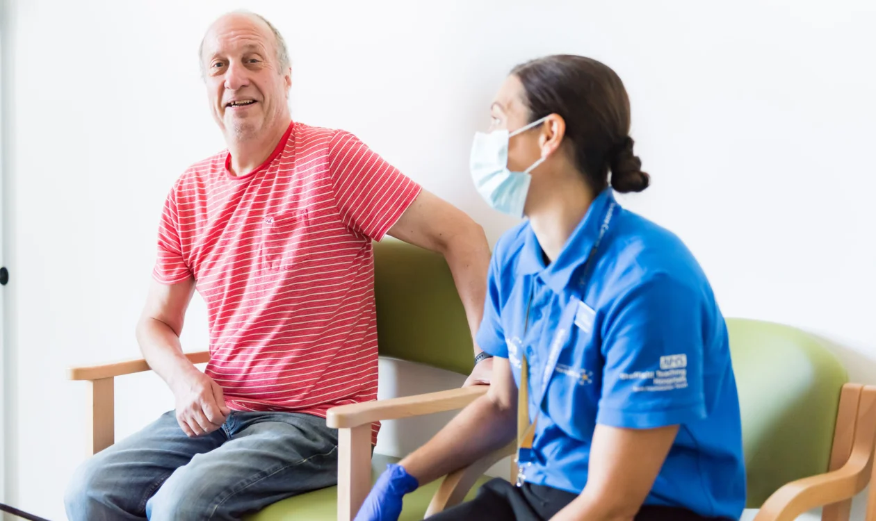 Patient looking happy in a consultation room with a clinician
