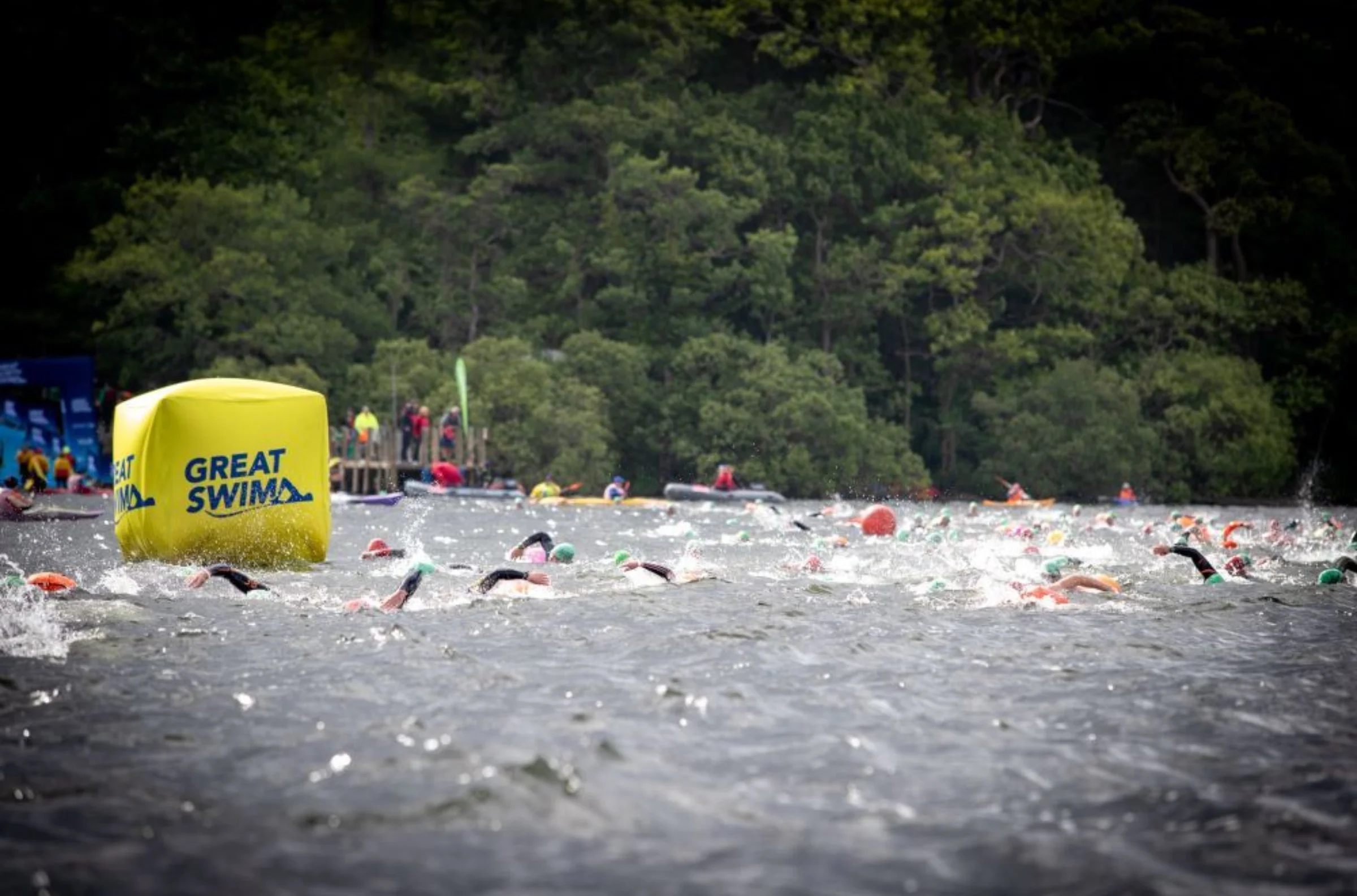 Lake with lots of swimmers competing.